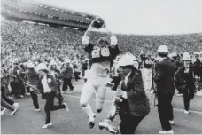  ?? ROBERT STINNETT, AP ?? California’s Kevin Moen crosses the goal line amid Stanford band members to score the winning TD in November 1982.