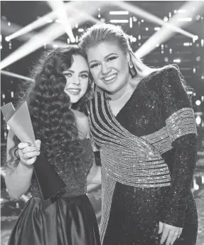  ?? PHOTOS BY TRAE PATTON/NBC ?? Coach Kelly Clarkson, right, was giddy after beating rival Blake Shelton with a country singer, young Chevel Shepherd.