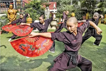  ??  ?? The Kung Fu Nuns group in New Delhi travel across South Asia to promote awareness about human traffickin­g. (AFP)