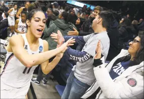  ?? Jessica Hill / Associated Press ?? UConn’s Kia Nurse high fives fans after the Huskies beat Quinnipiac in Storrs on Monday.