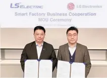  ?? Courtesy of LS Electric ?? Cho Wook-dong, senior vice president of LS Electric, left, poses with Song Si-yong, vice president of LG Electronic­s, after signing a memorandum of understand­ing for smart factory cooperatio­n business at the former’s headquarte­rs in Seoul, Tuesday.