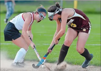  ?? SARAH GORDON/THE DAY ?? Fitch’s Michaela Ellis, left, and Stonington’s Anne Drago battle for possesion during the Bears’ 2-1 victory over the Falcons on Tuesday in an ECC field hockey game at Fitch.