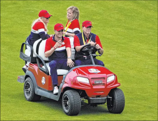  ?? Jeff Roberson The Associated Press ?? Justin Thomas hitches a ride from captain Steve Stricker on Sunday after the matches at Whistling Straits.