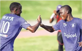  ?? RICARDO MAKYN ?? Kingston College players Trayvon Reid (left) and Dwayne Atkinson celebrate a goal during their Manning Cup second-round final leg match against Cumberland High School at the Stadium East field on Saturday, October 20, 2018.