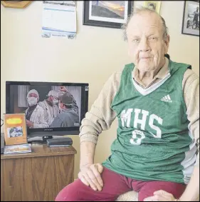  ?? SHARON MONTGOMERY-DUPE/ SALTWIRE NETWORK ?? Clyde Harvey, 66, of North Sydney, sits by the television, VCR and phone he received for Christmas from strangers — items which he never owned prior to the holiday season — while proudly wearing a jersey given to him by the Memorial High School boys varsity basketball team. Harvey, originally of Ingonish, had spent Christmas Day alone for the previous 16 years.