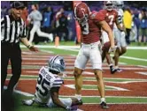  ?? CHRIS GRAYTHEN/GETTY ?? Alabama’s Jermaine Burton, right, stands over KSU’s Ekow Boye-Doe after scoring a touchdown in the Sugar Bowl on Saturday in New Orleans.
