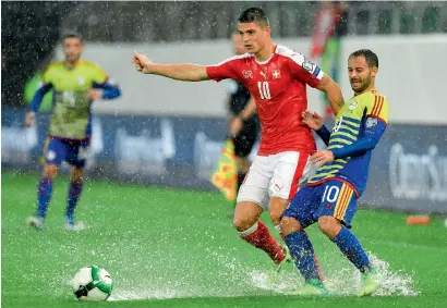  ?? AP file ?? Swiss midfielder Granit Xhaka (No. 10) is challenged by Andorra’s Ludovic Clemente during the 2018 World Cup group B qualificat­ion match. Switzerlan­d take on Northern Ireland in the first leg of a two-leg playoff on Thursday. —