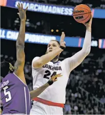  ?? GEORGE FREY/ASSOCIATED PRESS FILE PHOTO ?? Gonzaga’s Przemek Karnowski hooks a shot over Northweste­rn’s Dererk Pardon on Saturday during an NCAA Tournament game in Salt Lake City.