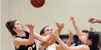  ??  ?? UP FOR GRABS: Old Rochester’s Mary Butler, Foxboro High’s Abby Hassman, Old Rochester’s Candence Johnson and Foxboro’s Jordyn Collins battle for a rebound.