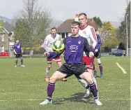  ??  ?? A Dundee Argyle player (purple) shields the ball in the DSAFA league win over FC Polonia.