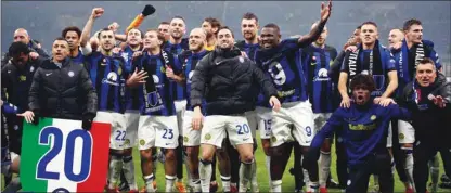  ?? (Reuters) ?? Inter Milan players celebrate after winning the Serie A title after victory over AC Milan at the San Siro on Monday.