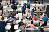  ??  ?? Travelers wear face masks while passing through the south security checkpoint in the main terminal of Denver Internatio­nal Airport on Tuesday in Denver. (AP Photo/David Zalubowski)