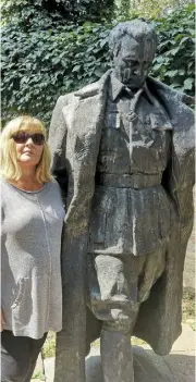  ??  ?? Eleanor with a statue of Tito in Belgrade