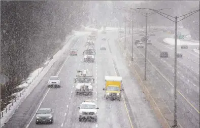  ?? H John Voorhees III / Hearst Connecticu­t Media ?? Snow falls on eastbound traffic on I-84, midday on Jan. 28. Legislatio­n passed by lawmakers on Friday aims to dramatical­ly lower tailpipe emissions in Connecticu­t by adding thousands of new electric vehicles to the state’s roads.