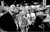  ?? DAVID GOLDMAN/AP ?? Attendees view Donald Trump’s speech from a TV in the exhibition hall at the NRA conference Friday in Atlanta.