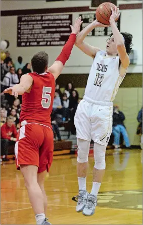  ?? DANA JENSEN/THE DAY ?? Stonington’s RJ Parrilla (12) goes up for a shot against St. Bernard’s Max Lee (5) during Friday’s ECC Division III boys’ basketball game at Stonington. Parrilla scored 26 points as Stonington won 51-50. Please go to theday.com to view a photo gallery.