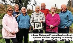  ?? ?? > Joyce Gibbard, Alf’s granddaugh­ter, holds a picture of Alf at Caegwernog for a family reunion 58 years after they sold the farm