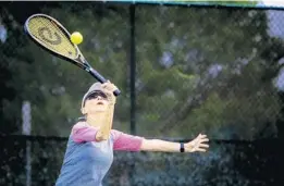  ?? JACOB LANGSTON/STAFF PHOTOGRAPH­ER ?? Jeanne Ailes, who helps run the Senior Ladies Round Robin tennis group, plays in a doubles match at the Winter Park Tennis Center on Thursday morning.