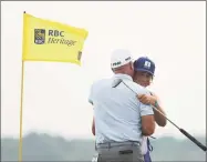  ?? Patrick Smith / Getty Images ?? Stewart Cink celebrates with his caddie and son, Reagan Cink, on the 18th green after winning the RBC Heritage on Sunday.