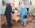  ?? VICTORIA JONES/AP ?? Britain’s Queen Elizabeth II welcomes Boris Johnson, newly elected leader of the Conservati­ve party, at Buckingham Palace.