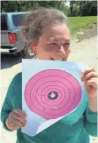  ?? PAUL A. SMITH ?? Ramona Collett of Butler proudly holds a paper target with evidence of bull’s-eyes she shot with a handgun. Collette’s son Robert of Sussex has been treated for Hodgkin’s lymphoma.
