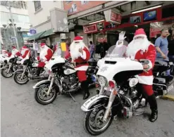  ?? SANTAS ON WHEELS: — Reuters ?? Members of the transit police dressed as Santa Claus sit on their motorcycle­s in downtown Monterrey, Mexico, on Tuesday.