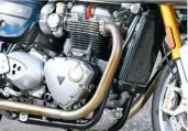  ??  ?? Triumph’s 1200 parallel twin looks old-school outside but is state-of-the-art inside