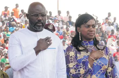  ?? Pictures: Reuters ?? TAKING THE OATH. Liberia’s new President George Weah stands with his wife, Clar, as they attend his swearing-in ceremony at the Samuel Kanyon Doe Sports Complex in Monrovia, Liberia on Monday.