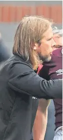  ??  ?? Souttar gets a pointer from Hearts assistant boss Austin MacPhee.