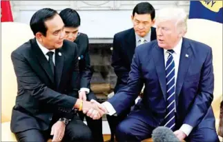  ?? MANDEL NGAN/AFP ?? US President Donald Trump and Thailand’s Prime Minister Prayut Chan-o-cha shake hands as they take part in a meeting in the Oval Office of the White House on October 2.