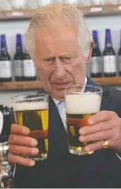  ?? PAUL CHIASSON
/ THE CANADIAN PRESS ?? Prince Charles compares beer at the Quidi Vidi Brewery, located in a fishing village in the east end of St. John's,
on his and Camilla's Canadian tour on Tuesday.