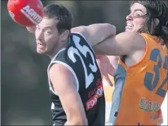  ??  ?? TANGLED: Edenhope-apsely coach Michael Rowe tussles with Southern Mallee Giants’ Sam Weddell during a match last year.