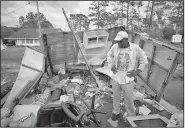  ?? AP/The News & Observer/ROBERT WILLETT ?? Tony Thompson looks at damage at his mobile home Sunday in Newport, N.C., following Hurricane Florence. Thompson says he feels lucky to be alive after losing his home and most of his possession­s.