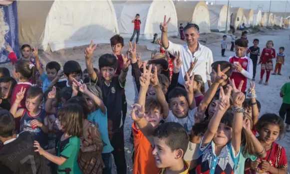  ?? PETER BREGG ?? Payam Akhavan in a Yazidi refugee camp in Iraq this summer. The lawyer is helping to set up a truth commission in Iraqi Kurdistan for Yazidis who have been victimized by Daesh.