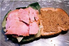  ?? PHOTO BY SHERREL JONES, THE OKLAHOMAN ?? Holiday leftovers make a hearty sandwich for lunch.