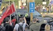  ?? [AP PHOTO/CARLOS VARGAS] ?? In this image from video, President Donald Trump waves as he drives past supporters gathered outside Walter Reed National Military Medical Center in Bethesda, Md., on Sunday, Oct. 4. Trump was admitted to the hospital after contractin­g COVID-19.