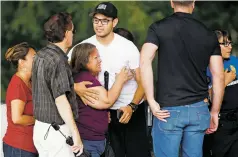  ??  ?? Family members of the deceased console one another at the scene where the bodies were found Thursday on Don Gaspar Avenue.