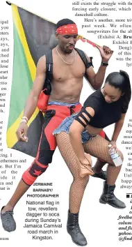  ?? JERMAINE BARNABY/ PHOTOGRAPH­ER ?? National flag in tow, revellers dagger to soca during Sunday’s Jamaica Carnival road march in Kingston.