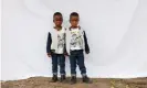  ??  ?? Five-year-old twins Syanda, left, and Andile Bhengu pose for a photograph during a celebratio­n for the 21 pairs of twins at their primary school in Durban, South Africa. Photograph: Kim Ludbrook/EPA