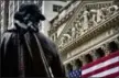  ?? BEBETO MATTHEWS — THE ASSOCIATED PRESS FILE ?? Federal Hall’s George Washington statue stands near the flagcovere­d pillars of the New York Stock Exchange.
