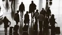  ?? Rick Bowmer / Associated Press ?? Travelers walk through the Salt Lake City Internatio­nal Airport in Utah on the day before Thanksgivi­ng.