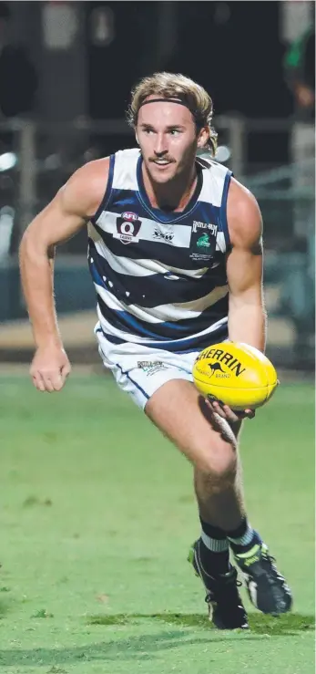  ??  ?? Port Douglas Crocs’ Jackson McDonald looks to handball. Picture: Stewart McLean