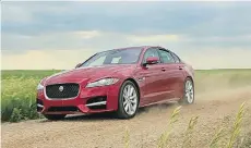  ?? SANDY HUFFAKER/JAGUAR ?? “Tornado” Tim Baker drives toward an incoming super cell outside Montevideo, Minn., in the Jaguar XF.