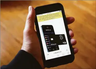  ?? Peter Morgan / Associated Press ?? Text, in yellow, announcing cryptocurr­ency lender BlockFi's bankruptcy filing appears on the company website on a smartphone Monday. BlockFi said it was filing for bankruptcy protection to stabilize its business and give it the chance to perform a restructur­ing.