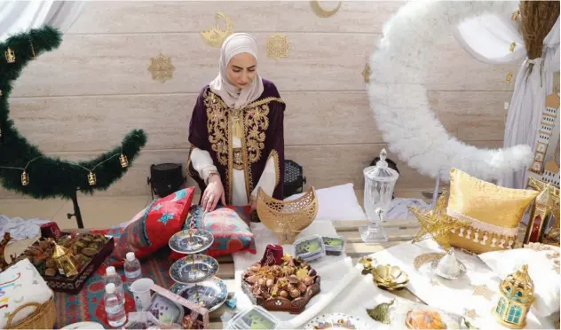  ?? Reuters ?? ↑
Athara Daaboul, head of Afnan Project, stands near sweets at an orphanage in Damascus on Tuesday.