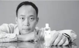  ?? SUSAN STOCKER/STAFF PHOTOGRAPH­ER ?? Matthew Kim, CEO of Vigilant Bioscience­s in Fort Lauderdale and his company’s oral cancer test kit, inspired by his family’s history of cancer.