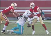  ?? NHAT V. MEYER — BAY AREA NEWS GROUP ?? Miami Dolphins’ Emmanuel Ogbah (91) knocks the ball out of San Francisco 49ers quarterbac­k C.J. Beathard’s (3) hands for a turnover in the fourth quarter at Levi’s Stadium in Santa Clara on Sunday.