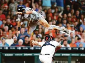  ?? Jon Shapley / Houston Chronicle ?? The White Sox’s Adam Eaton is tagged out at home by Astros catcher Evan Gattis despite a valiant leap to avoid the tag in the third inning of Saturday’s game.