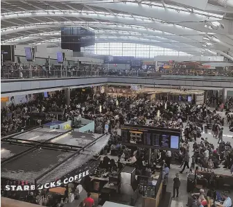  ?? APPHOTOs ?? STALLED: Passengers faced hourslong lines to check in, reclaim lost luggage or rebook flights at Terminal 5, British Airlines’ hub at Heathrow Airport in London.