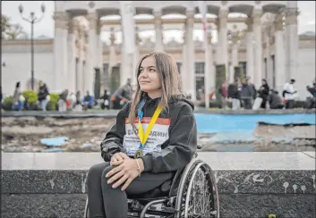  ?? Bram Janssen The Associated Press ?? Elina Okolit poses for a portrait after participat­ing in a one-kilometer race to raise money for the Ukrainian military on Sunday in Kyiv, Ukraine.